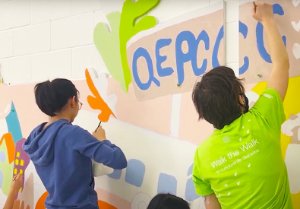 Youth volunteer painting the “A trip through town” Youth Mural Project at Queen Elizabeth Park Community and Cultural Centre. Youth volunteer painting the “A trip through town” Youth Mural Project at Queen Elizabeth Park Community and Cultural Centre.
