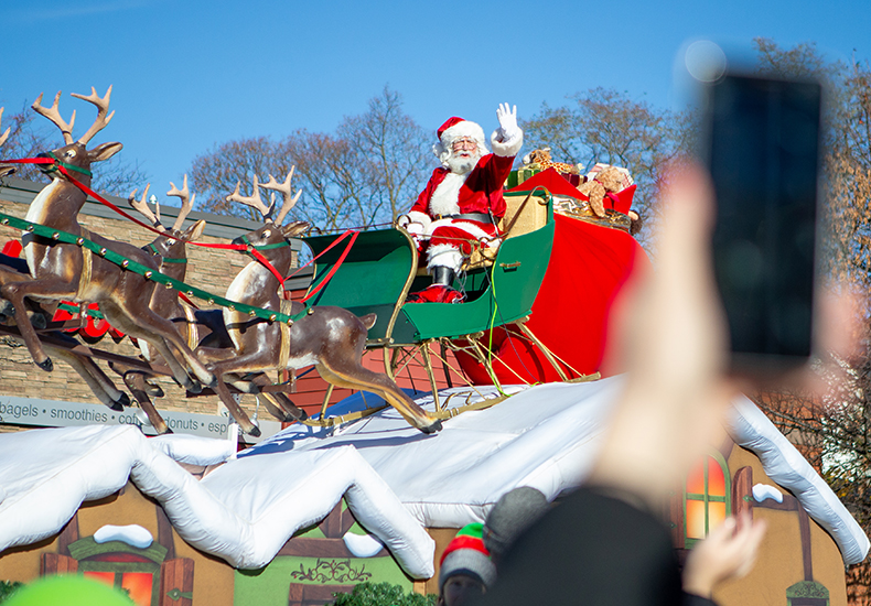 The Oakville Santa Claus Parade A hand holding a mobile phone snaps a photo of Santa during the Oakville Santa Claus Parade.