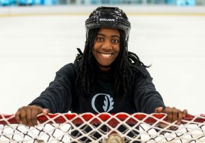 A facility services staff moving a hockey net.