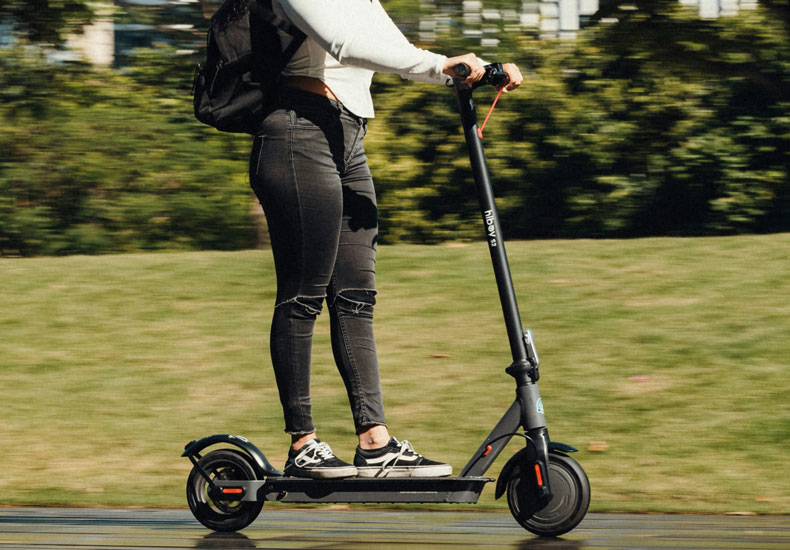 E-scooter A person riding an electric scooter.