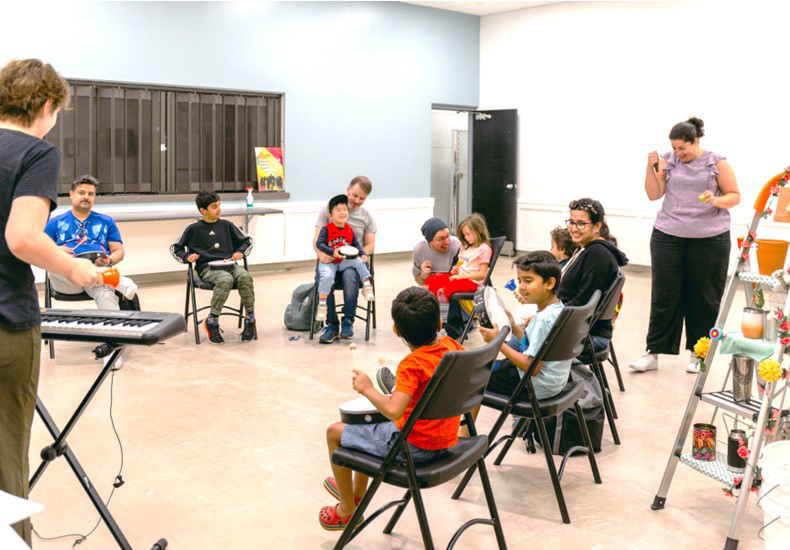 Children and parents playing instruments at Bandology Culture Days event