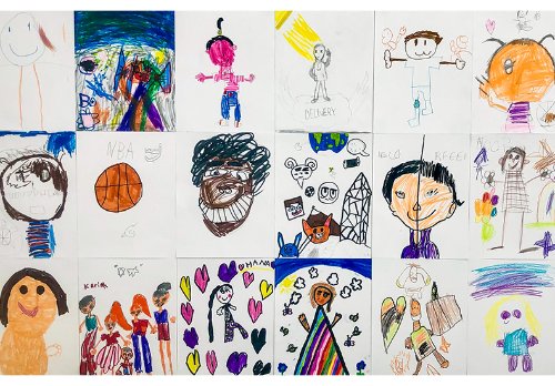 Close up of a selection of portraits hand drawn by children in a gallery Close up of a selection of portraits hand drawn by children in a gallery