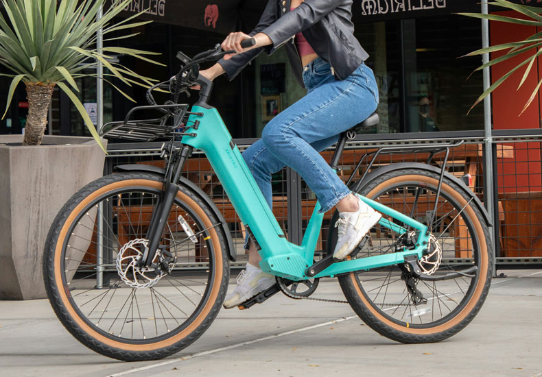 A person sitting on an electric bicycle.
