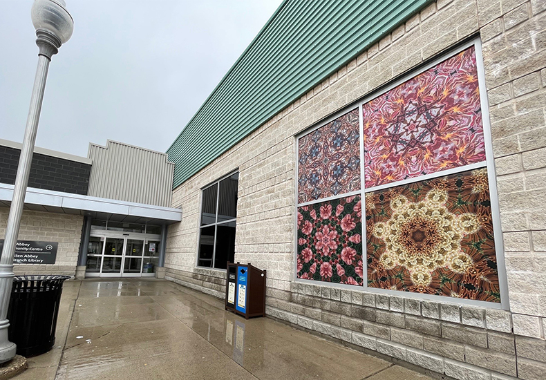 Connextions summer 2023 artwork by Alex Neumann displayed in a window at Glen Abbey Community Centre