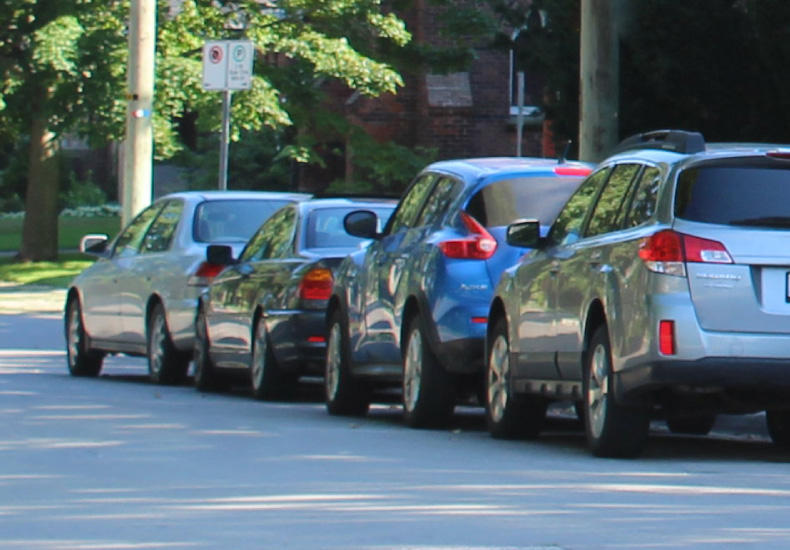 A row of cars parked on a street.