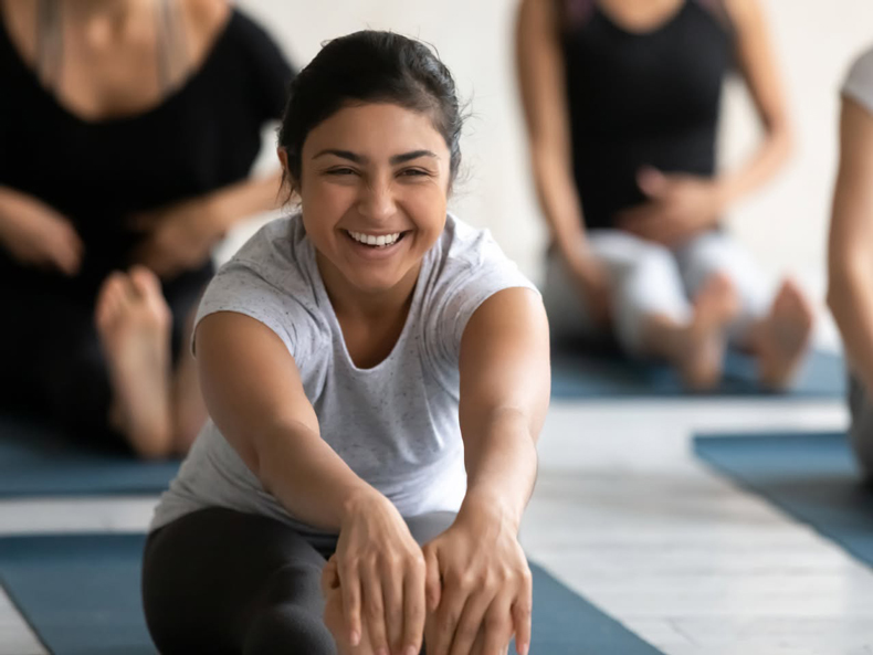 Smiling person doing yoga