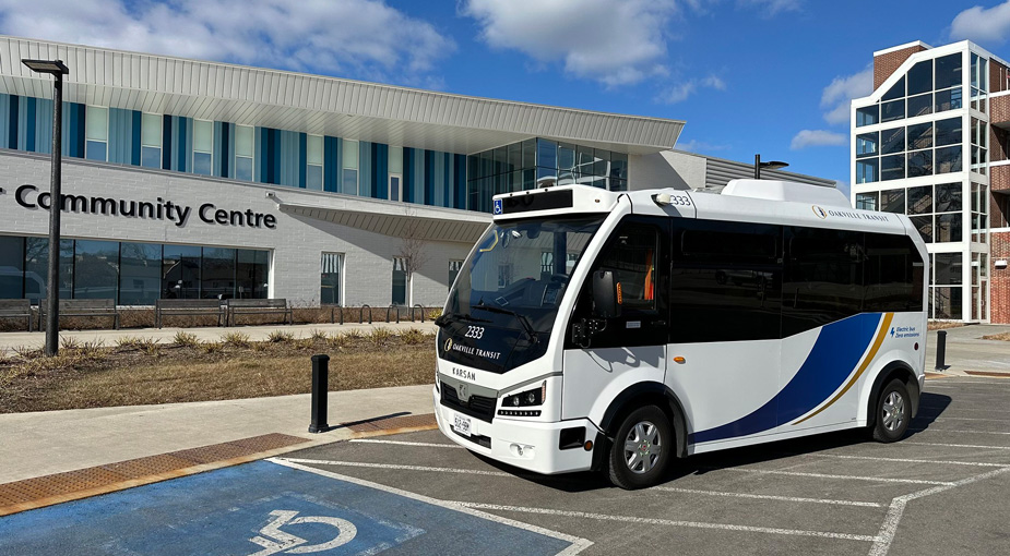 Electric bus waiting at a community centre