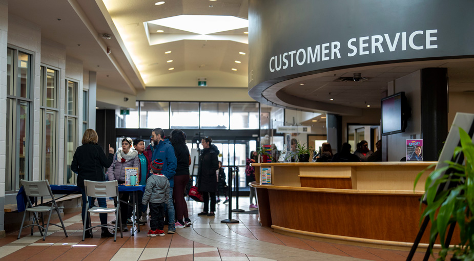 Customers interacting with staff in a community centre