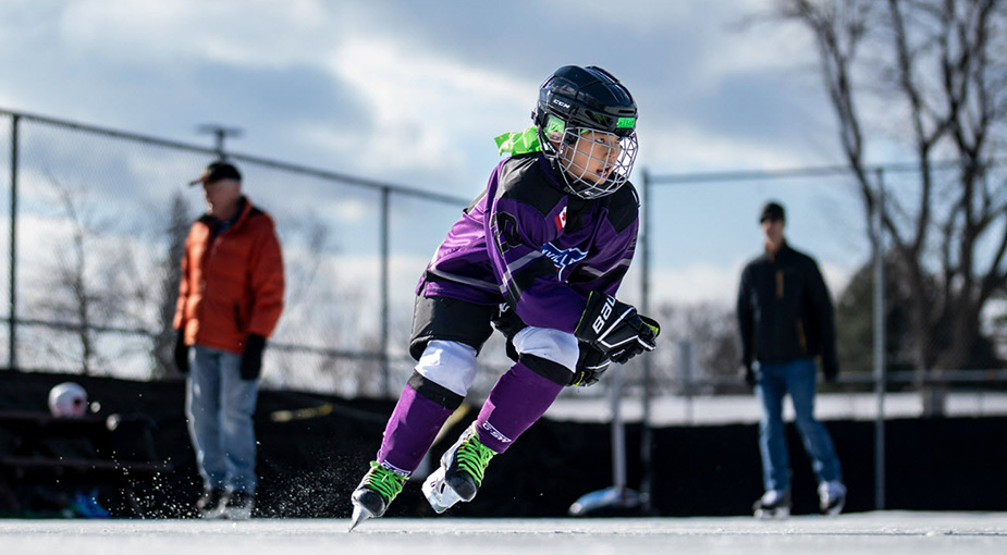 Child skating at an outdoor ice rink